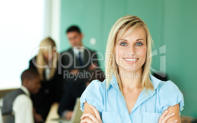 Businesswoman in front of people working in an office