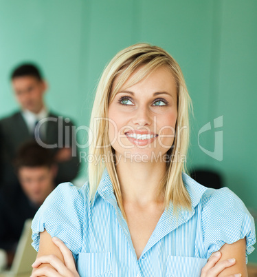 Businesswoman in front of an office with people working