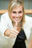 Businesswoman smiling with her thumbs up