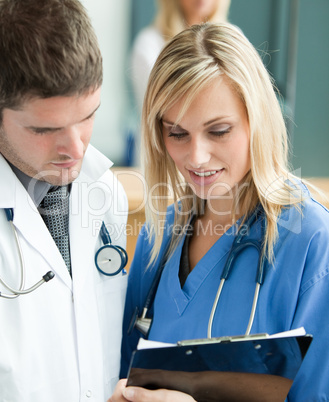 Young doctors reading a report