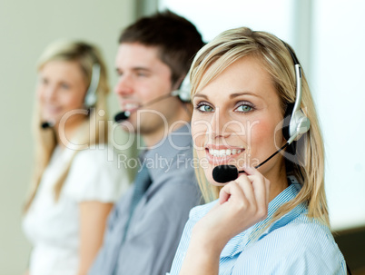 Three businesspeople working with headsets