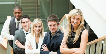 Businesspeople looking at the camera with folded arms
