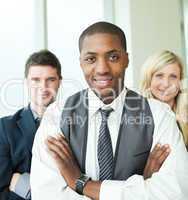 Afro-American businessman with his colleagues smiling at the cam