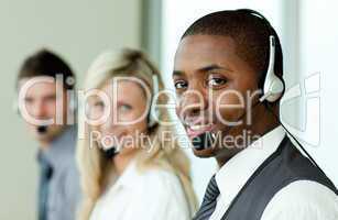 Businesspeople wearing headsets and smiling