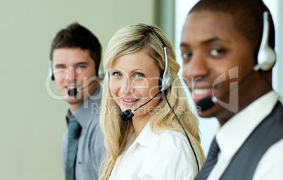 Three business people working with headsets