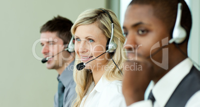 Three business people working with headsets