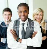 Afro-American businessman with folded arms with his colleagues