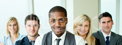Business team in a row with ethnic manager in the center