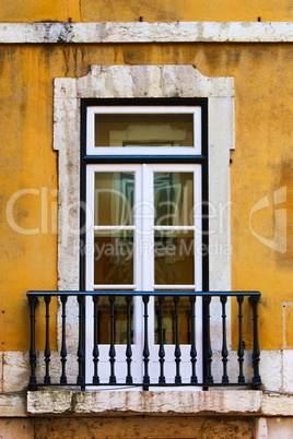 window in old yellow wall