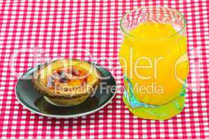 glass of orange juice and cake