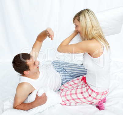 Lovers having a pillow fight