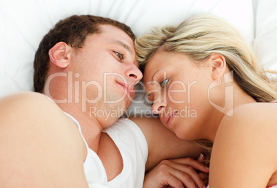 Intimate couple relaxing in bed