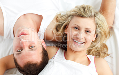 Happy couple resting in bed