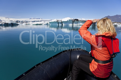 Woman Explorer Using Boat in Iceberg Field, Jokulsarlon Lagoon,