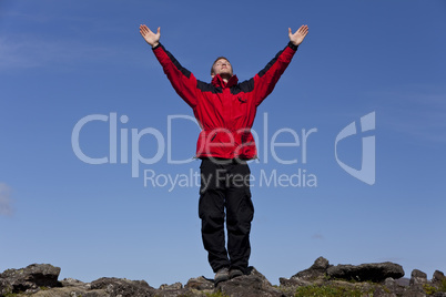 Man Celebrating Success On Top Of A Mountain