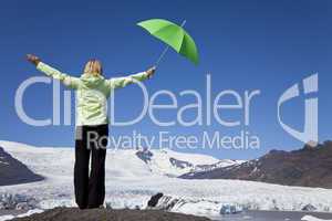 Woman With Green Umbrella In Front Of Melting Glacier
