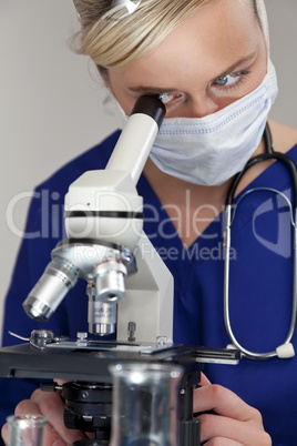 Female Scientist or Woman Doctor Using Microscope in a Laborator