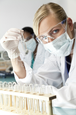 Female Scientist or Doctor With Clear Solution In Laboratory