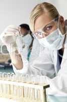 Female Scientist or Doctor With Clear Solution In Laboratory