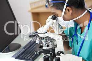 Asian Woman Doctor or Scientist Using a Microscope In Laboratory