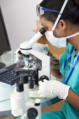 Asian Woman Doctor or Scientist Using a Microscope In Laboratory