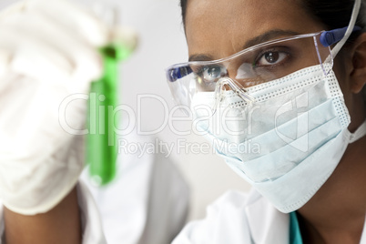 Asian Female Scientist or Doctor With Green Solution In Laborato