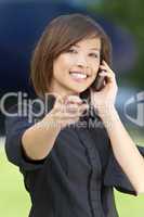 Beautiful Oriental Woman on Her Smart Cell Phone and Pointing