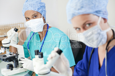 Female Scientific Research Team Using Microscopes in a Laborator