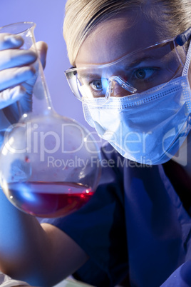 Female Scientist or Doctor With Red Liquid In Laboratory