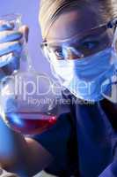 Female Scientist or Doctor With Red Liquid In Laboratory