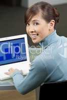 Beautiful Female Asian Executive Using a Laptop Computer