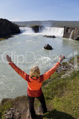 Woman Celebrating At Godafoss Waterfall, Iceland