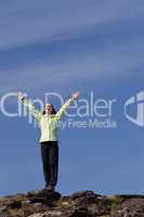 Woman Celebrating Achievement At The Top Of A Mountain