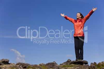 Woman Celebrating Achievement At The Top Of A Mountain