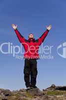 Man Celebrating Success On Top Of A Mountain