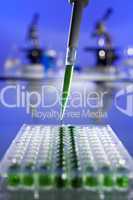 Green Solution Scientific Research With a Pipette and Cell Plate