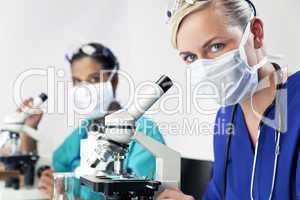 Female Scientific Research Team Using Microscopes in a Laborator