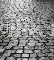 Wet cobbles of block pavement