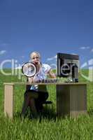 Woman Using Megaphone In A Green Field