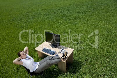 Woman Relaxing At An Office Desk