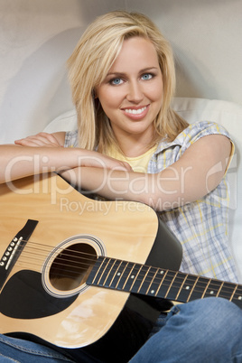 Beautiful Young Woman Playing A Guitar
