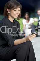 Woman Texting and Drinking Coffee