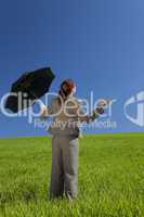 Woman In A Green Field With Umbrella
