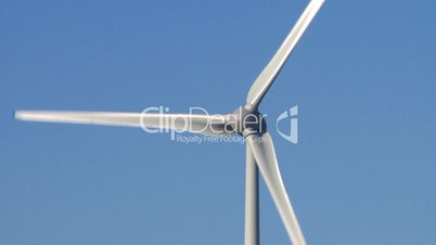 Wind power turbine detail on blue sky