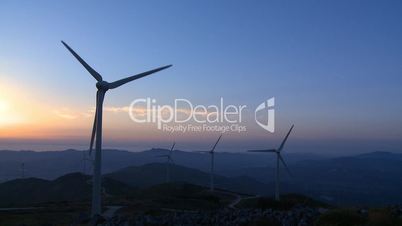 Wind turbine in the mountains at sunset