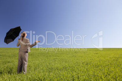 Business Concept Woman In A Green Field With An Umbrella