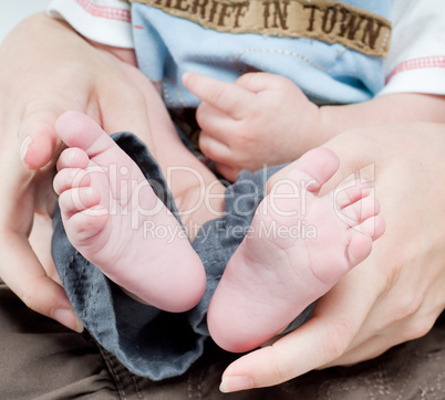 Newborn child in caring hands