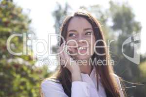 Girl call  phone and smile in autumn park