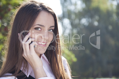 Girl call  phone and smile in autumn park