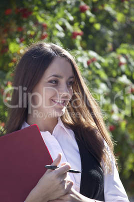 Young woman work with pen in park and smile